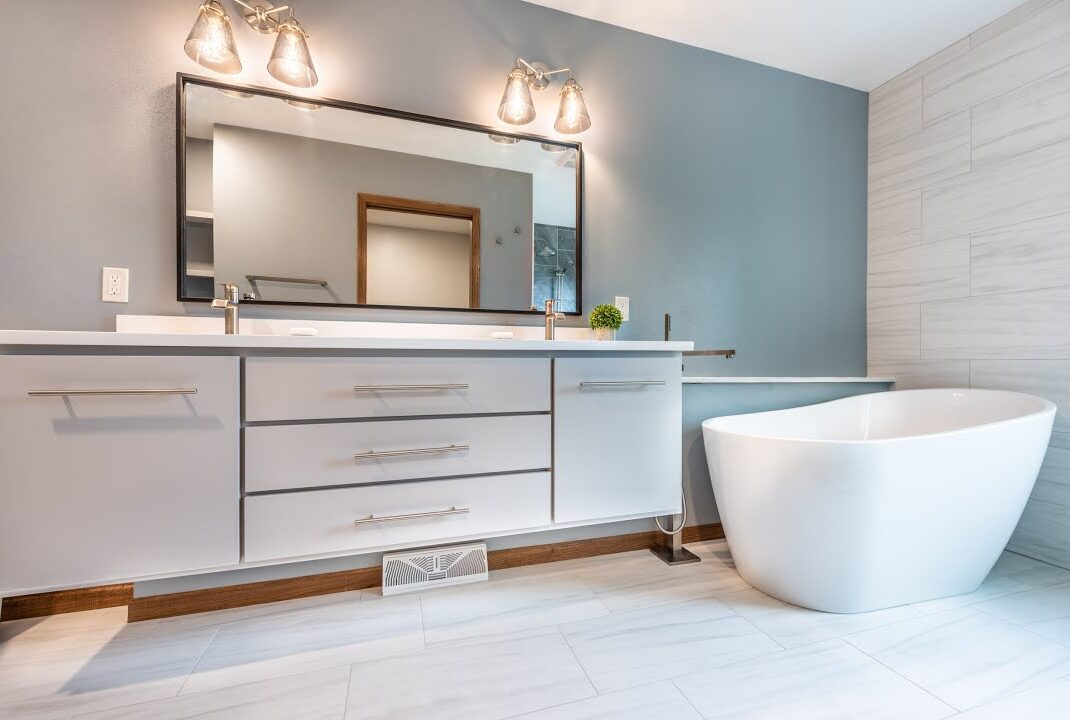 Premium Bathroom Remodeling Electrical with a sleek double vanity, stylish lighting, oversized mirror, and freestanding soaking tub for a contemporary upgrade.