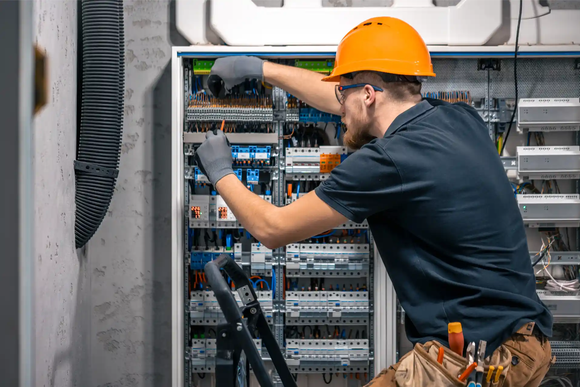 Commercial Electrical Services technician installing and inspecting an electrical control panel for safe, reliable, and efficient commercial power distribution.