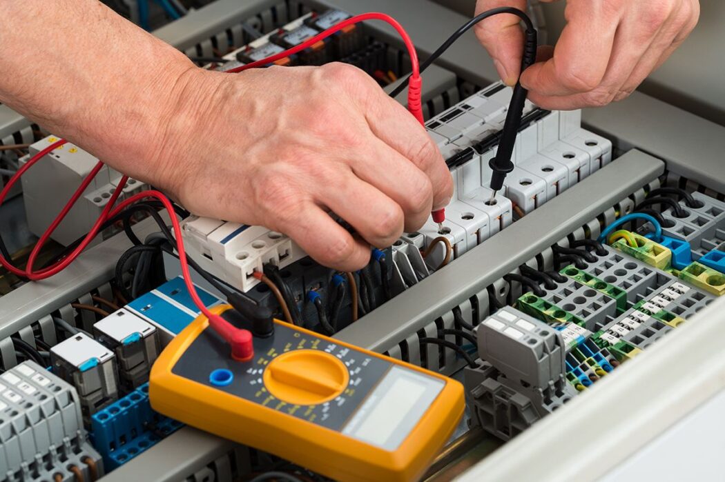 Home Electrical Maintenance and Repair professional testing electrical components with a multimeter for safe, reliable home systems.