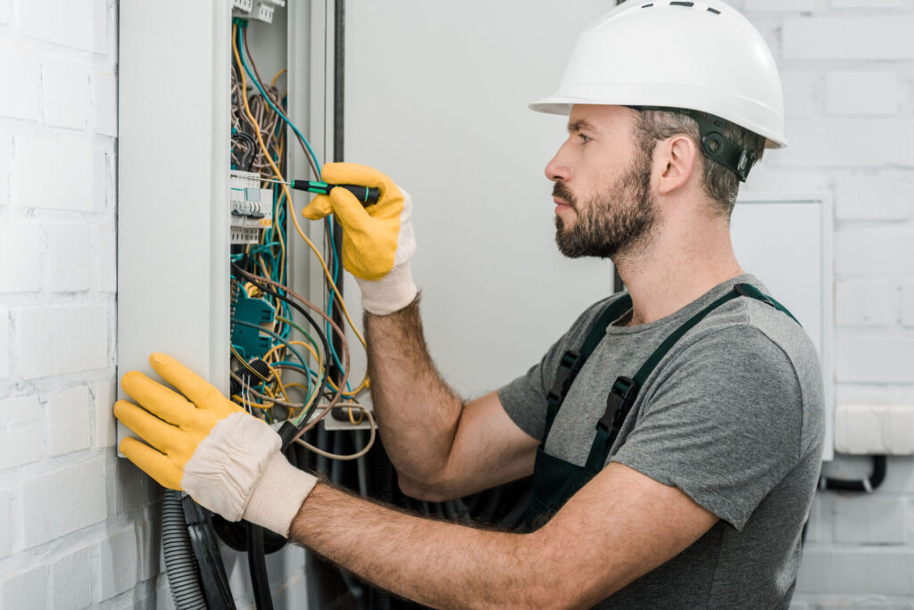 Home Electrical Maintenance and Repair technician inspecting a residential electrical panel to ensure safe, dependable wiring.