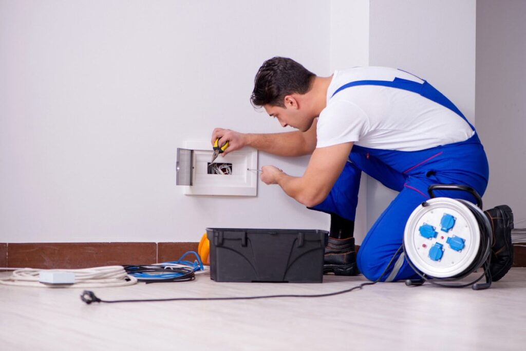 Home Electrical Maintenance and Repair expert safely servicing a residential electrical panel with professional tools.